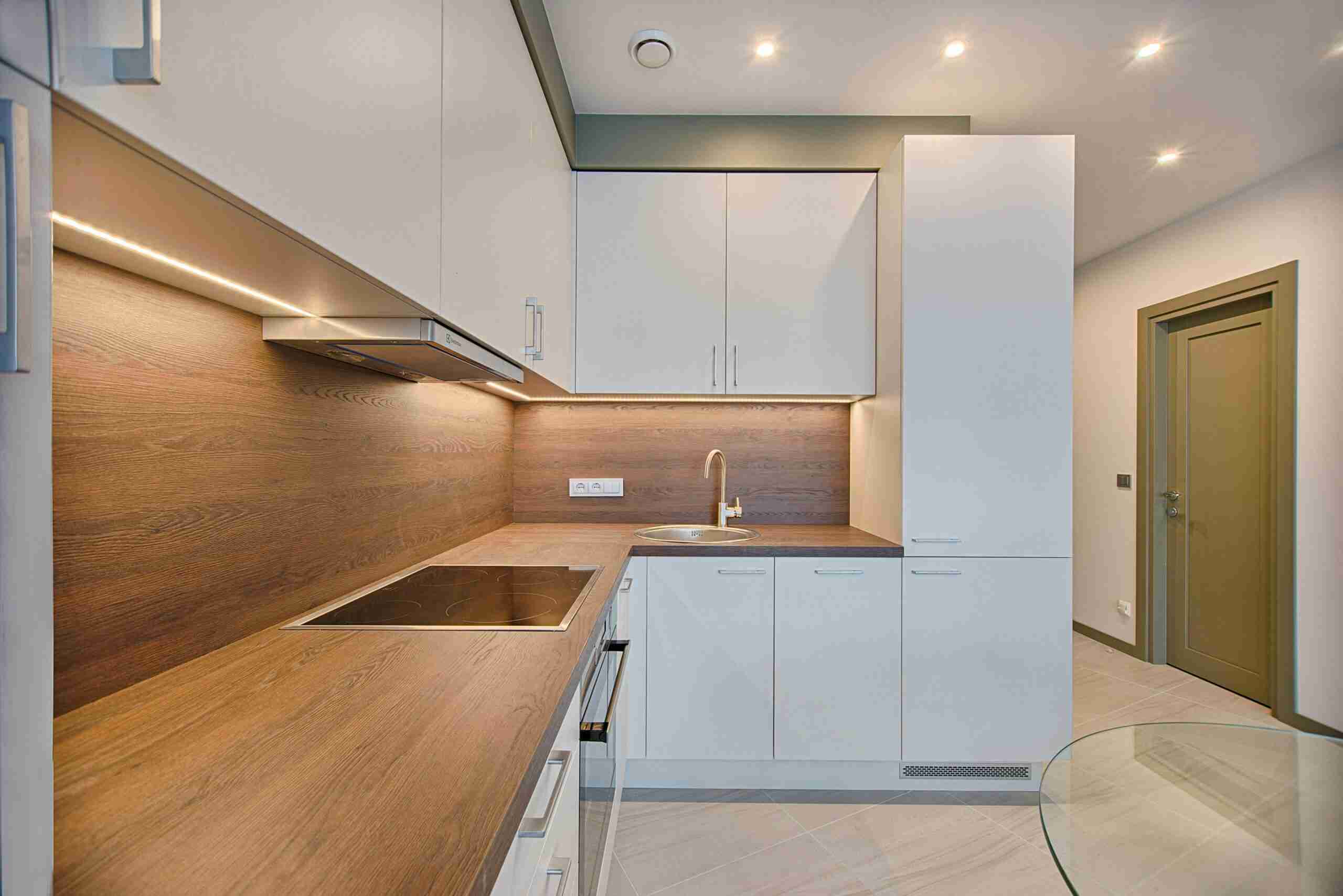 insurance crm Modern kitchen interior with minimalistic design and wooden accents, captured with natural lighting.