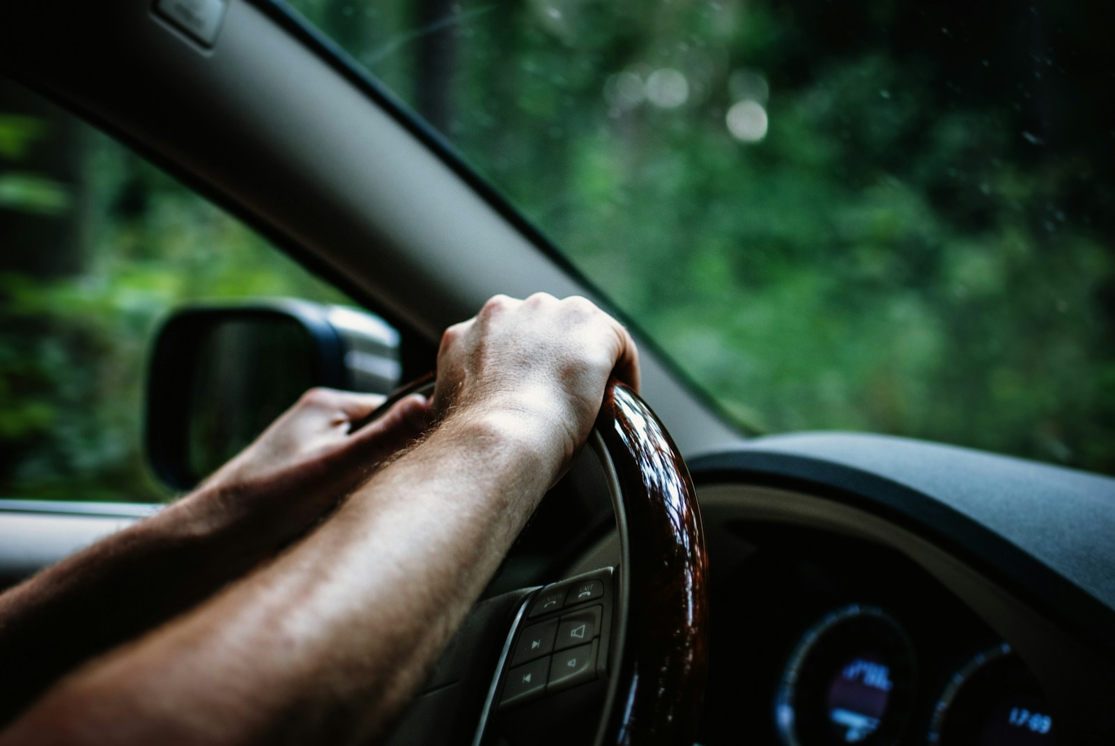 person holding car steering wheel, auto